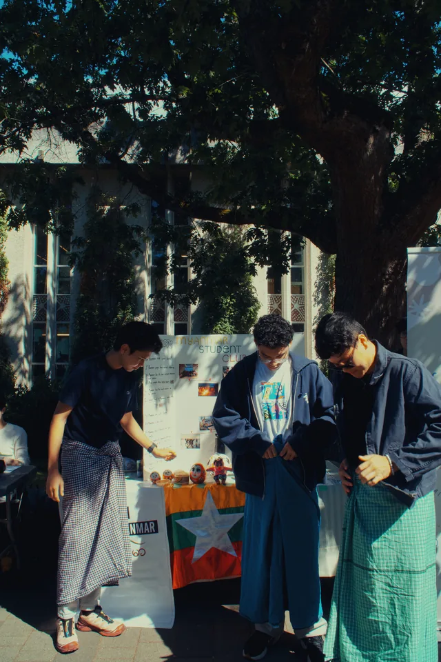 Club members wearing longyi at the Imagine Day 2026 booth