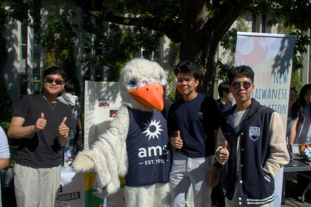Club members posing with the UBC Thunderbird mascot at the Imagine Day booth