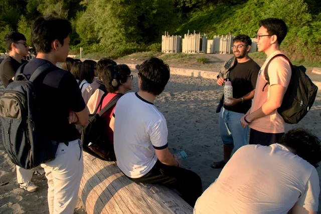 UBC Myanmar Club members chatting together at the beach